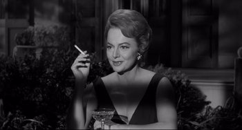 Movie still from “Hush...Hush, Sweet Charlotte” (1964), directed by Robert Aldrich – A black and white photo of a woman smoking a cigarette; Close Up shot, Low angle