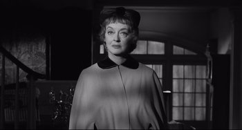 Movie still from “Hush...Hush, Sweet Charlotte” (1964), directed by Robert Aldrich – An old photo of a woman with a bow in her hair; Close Up shot, Low angle