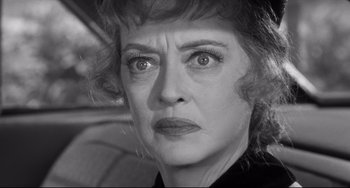 Movie still from “Hush...Hush, Sweet Charlotte” (1964), directed by Robert Aldrich – An older woman with big eyes stares at the camera; Close Up shot, Over the shoulder angle