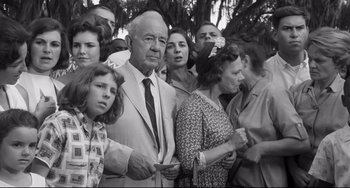 Movie still from “Hush...Hush, Sweet Charlotte” (1964), directed by Robert Aldrich – An old photo of a group of people gathered together; Medium shot, Low angle