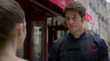 Movie still from “Emily in Paris” (2020), created by Darren Star – A man wearing a chef's outfit talking to another man; Close Up shot, Over the shoulder angle