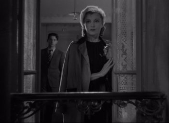 Movie still from “Hotel du Nord” (1938), directed by Marcel Carné – A man and a woman standing in front of a window; Medium shot, Low angle