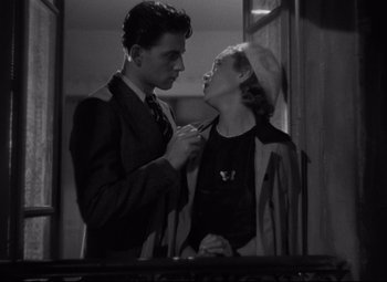 Movie still from “Hotel du Nord” (1938), directed by Marcel Carné – A man and a woman are looking into each others eyes; Medium shot, Low angle