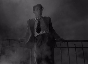 Movie still from “Hotel du Nord” (1938), directed by Marcel Carné – A black and white photo of a man in a suit and tie; Medium shot, Low angle