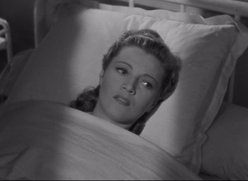 Movie still from “Hotel du Nord” (1938), directed by Marcel Carné – A black and white photo of a woman laying in a bed; Close Up shot, High angle