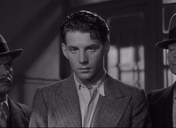 Movie still from “Hotel du Nord” (1938), directed by Marcel Carné – A black and white photo of a man in a suit; Close Up shot, Low angle