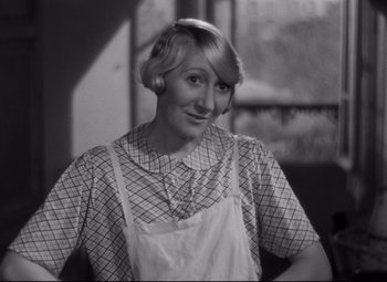 Movie still from “Hotel du Nord” (1938), directed by Marcel Carné – An old photo of a woman wearing an apron; Close Up shot, High angle