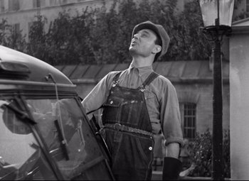 Movie still from “Hotel du Nord” (1938), directed by Marcel Carné – A man standing in front of a truck; Medium shot, Low angle