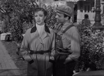 Movie still from “Hotel du Nord” (1938), directed by Marcel Carné – A man and a woman standing next to each other on a sidewalk; Medium shot, High angle