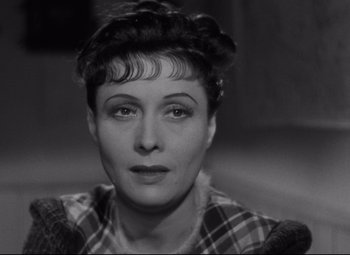 Movie still from “Hotel du Nord” (1938), directed by Marcel Carné – A black - and - white photo of a woman in a plaid shirt; Close Up shot, High angle