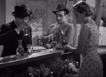 Movie still from “Hotel du Nord” (1938), directed by Marcel Carné – A group of people standing around a bar with drinks; Medium shot, High angle