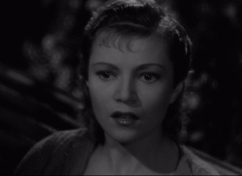 Movie still from “Hotel du Nord” (1938), directed by Marcel Carné – A black - and - white photo of a woman in a sweater; Close Up shot, High angle