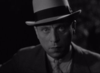 Movie still from “Hotel du Nord” (1938), directed by Marcel Carné – A black and white photo of a man wearing a hat; Close Up shot, Low angle