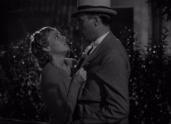 Movie still from “Hotel du Nord” (1938), directed by Marcel Carné – A man and a woman in a suit and tie; Medium shot, Low angle