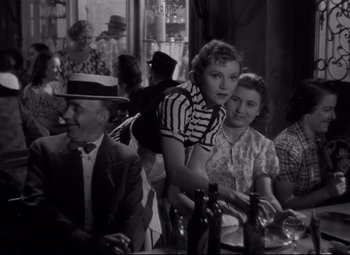 Movie still from “Hotel du Nord” (1938), directed by Marcel Carné – A man and a woman sitting at a table; Medium shot, Over the shoulder angle
