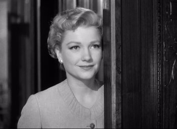 Movie still from “I Confess” (1953), directed by Alfred Hitchcock – An old photo of an older woman looking at the camera; Close Up shot, Low angle