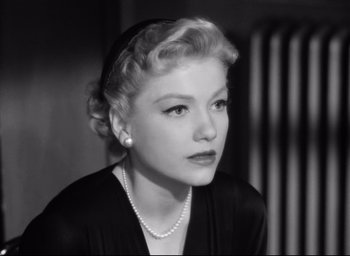 Movie still from “I Confess” (1953), directed by Alfred Hitchcock – An old photo of a woman with a pearl necklace; Close Up shot, Low angle