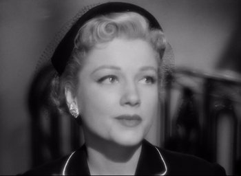 Movie still from “I Confess” (1953), directed by Alfred Hitchcock – An old photo of a woman in a black outfit; Close Up shot, High angle
