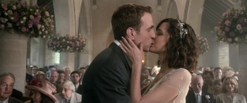 Movie still from “I Give It a Year” (2013), directed by Dan Mazer – A man and a woman kissing in front of an audience; Close Up shot, Low angle