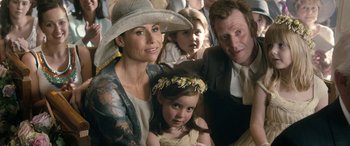 Movie still from “I Give It a Year” (2013), directed by Dan Mazer – A woman and two children are posing for a picture; Close Up shot, Over the shoulder angle