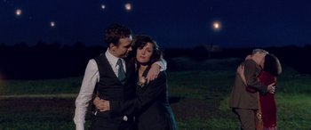Movie still from “I Give It a Year” (2013), directed by Dan Mazer – A man and a woman hugging in a field at night; Medium shot, Over the shoulder angle