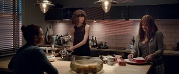 Movie still from “I Give It a Year” (2013), directed by Dan Mazer – A woman in a black dress is washing dishes; Medium shot, Over the shoulder angle