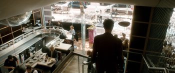 Movie still from “I Give It a Year” (2013), directed by Dan Mazer – People are sitting at tables in a restaurant; Wide shot, High angle