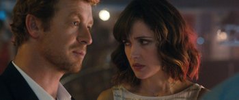 Movie still from “I Give It a Year” (2013), directed by Dan Mazer – A man and a woman looking at one another; Close Up shot, Over the shoulder angle