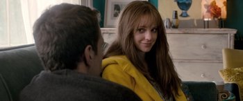 Movie still from “I Give It a Year” (2013), directed by Dan Mazer – A woman in a yellow jacket sitting next to a man; Close Up shot, Over the shoulder angle