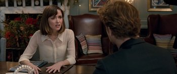 Movie still from “I Give It a Year” (2013), directed by Dan Mazer – A woman sitting at a table talking to a man; Close Up shot, Over the shoulder angle