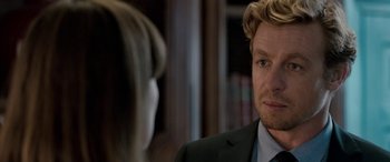 Movie still from “I Give It a Year” (2013), directed by Dan Mazer – A person wearing a suit and a tie; Close Up shot, Over the shoulder angle