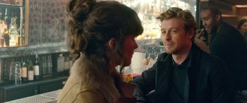 Movie still from “I Give It a Year” (2013), directed by Dan Mazer – A man and a woman are sitting at a table; Close Up shot, Over the shoulder angle