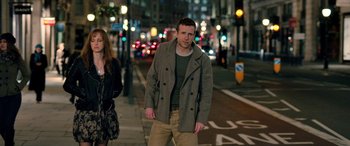 Movie still from “I Give It a Year” (2013), directed by Dan Mazer – A man and a woman walking down a street at night; Medium shot, Over the shoulder angle