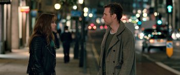 Movie still from “I Give It a Year” (2013), directed by Dan Mazer – A man and a woman standing next to each other on a sidewalk; Medium shot, Over the shoulder angle