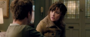 Movie still from “I Give It a Year” (2013), directed by Dan Mazer – A woman in a brown jacket talking to a man; Close Up shot, Over the shoulder angle