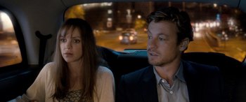 Movie still from “I Give It a Year” (2013), directed by Dan Mazer – A man and a woman sitting in the back of a car; Close Up shot, Over the shoulder angle