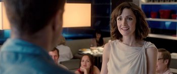 Movie still from “I Give It a Year” (2013), directed by Dan Mazer – A group of people sitting at a table in a restaurant; Medium shot, Over the shoulder angle