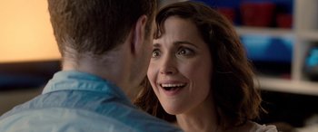 Movie still from “I Give It a Year” (2013), directed by Dan Mazer – A person smiling at the camera; Close Up shot, Over the shoulder angle