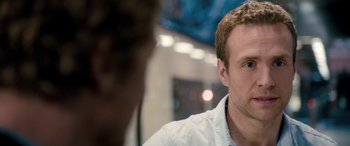 Movie still from “I Give It a Year” (2013), directed by Dan Mazer – A man's face as he sits in front of another man; Close Up shot, Over the shoulder angle