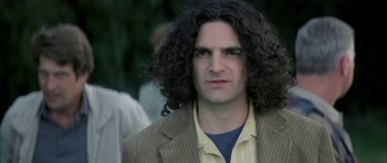 Movie still from “I Heart Huckabees” (2004), directed by David O. Russell – A person with long hair; Close Up shot, Low angle