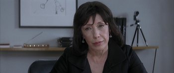 Movie still from “I Heart Huckabees” (2004), directed by David O. Russell – A person sitting in a room; Close Up shot, High angle