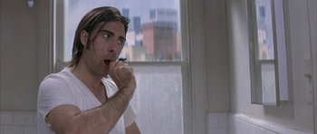Movie still from “I Heart Huckabees” (2004), directed by David O. Russell – A man brushing his teeth in front of a window; Close Up shot, Low angle
