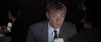Movie still from “I Heart Huckabees” (2004), directed by David O. Russell – A person wearing a suit and tie; Close Up shot, High angle