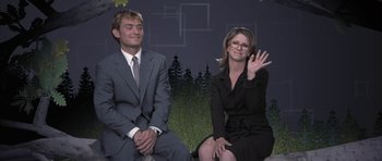 Movie still from “I Heart Huckabees” (2004), directed by David O. Russell – A man and a woman sitting next to each other; Medium shot, Low angle