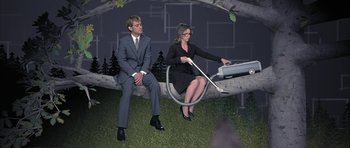 Movie still from “I Heart Huckabees” (2004), directed by David O. Russell – A man and a woman sitting on top of a tree branch; Wide shot, High angle