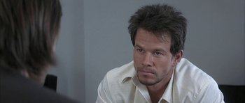 Movie still from “I Heart Huckabees” (2004), directed by David O. Russell – A person wearing a white shirt; Close Up shot, Over the shoulder angle