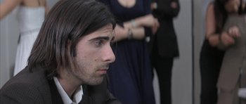 Movie still from “I Heart Huckabees” (2004), directed by David O. Russell – A person with long black hair; Close Up shot, Over the shoulder angle