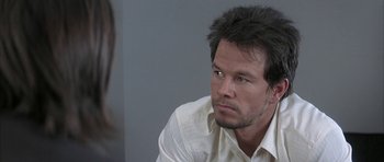 Movie still from “I Heart Huckabees” (2004), directed by David O. Russell – A person wearing a white shirt; Close Up shot, Over the shoulder angle