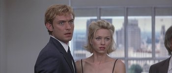 Movie still from “I Heart Huckabees” (2004), directed by David O. Russell – A man and a woman standing next to each other; Close Up shot, Low angle