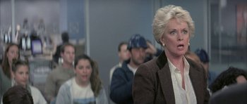 Movie still from “I Heart Huckabees” (2004), directed by David O. Russell – A group of people standing in a room; Close Up shot, Over the shoulder angle